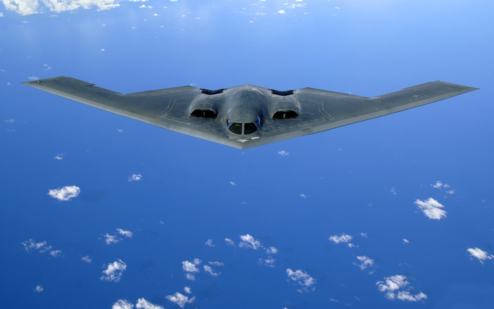 A B-2 Spirit stealth bomber in flight over the ocean